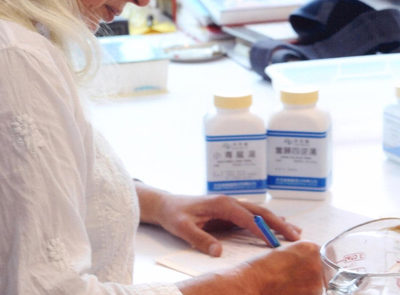 Sharon preparing a Chinese herbal formula